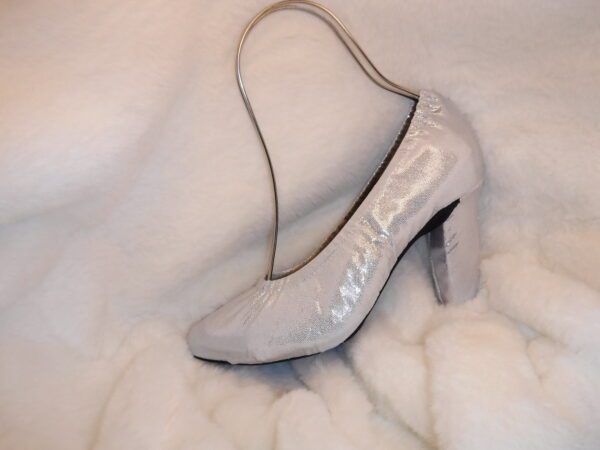 A gray color heel shoe on a white sheet