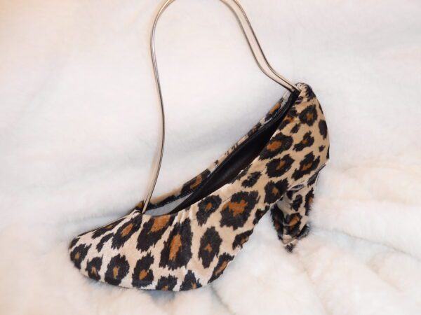 A tiger skin print heel sandle cover on a white sheet