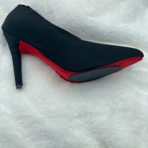 Black and red color heel sandle on a white cloth