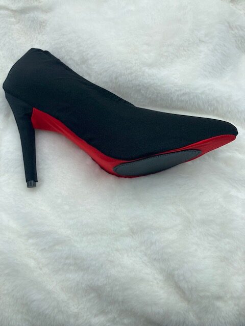 Black and red color heel sandle on a white cloth