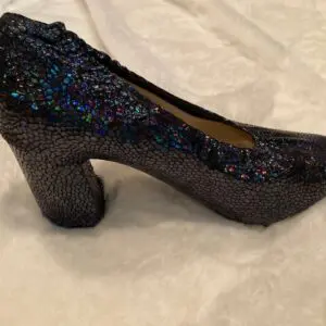 A blue sequin shoe cover on a white color sheet